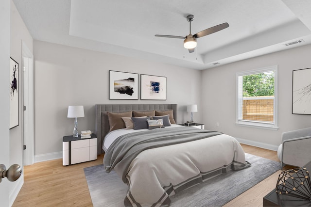 2247 Archer Ln, Augusta, GA 30906 - bedroom featuring a raised ceiling, light wood-style floors, and ceiling fan