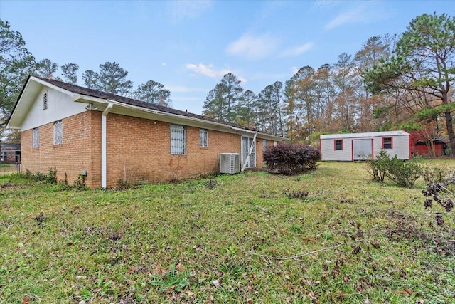 3639 Massoit Dr, Augusta, GA 30906 - view of home's exterior featuring cooling unit, an outdoor structure, brick siding, and a lawn