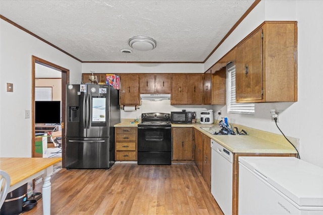3639 Massoit Dr, Augusta, GA 30906 - kitchen featuring black appliances, under cabinet range hood, light countertops, a textured ceiling, and ornamental molding