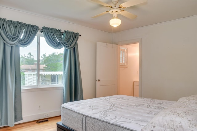 2336 Redwood Dr, Augusta, GA 30904 - bedroom with light wood-style floors, multiple windows, and a ceiling fan
