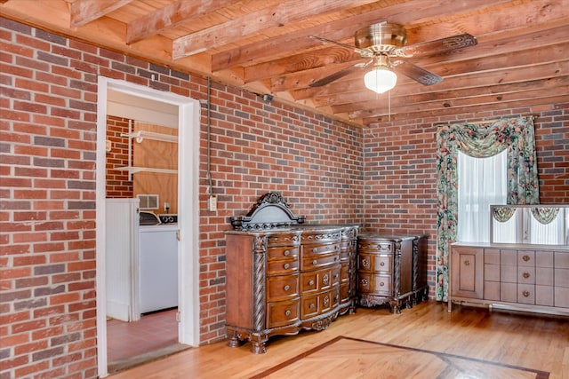 2336 Redwood Dr, Augusta, GA 30904 - detailed view of wood finished floors, brick wall, wooden ceiling with exposed beams, washer / dryer, and ceiling fan