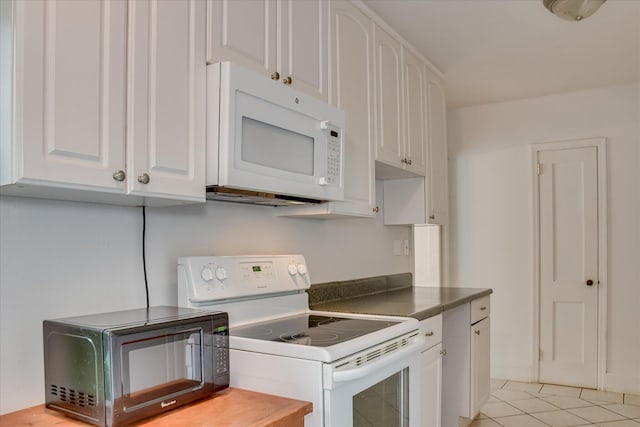 2336 Redwood Dr, Augusta, GA 30904 - kitchen with white appliances, white cabinetry, dark countertops, and light tile patterned floors