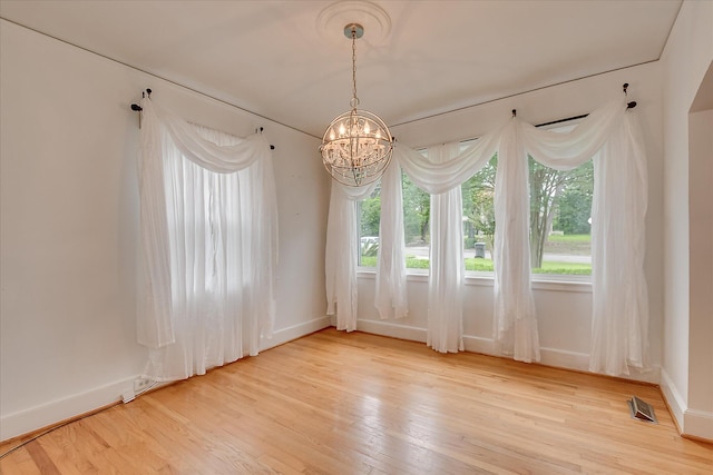 2336 Redwood Dr, Augusta, GA 30904 - spare room featuring a chandelier, light wood-style flooring, and baseboards