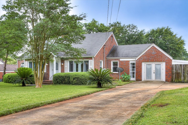 2336 Redwood Dr, Augusta, GA 30904 - view of front facade with brick siding, roof with shingles, a front lawn, french doors, and driveway