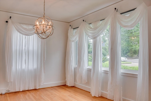 2336 Redwood Dr, Augusta, GA 30904 - unfurnished dining area with baseboards, a chandelier, light wood-style flooring, and healthy amount of natural light