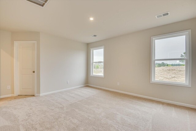 empty room featuring light colored carpet