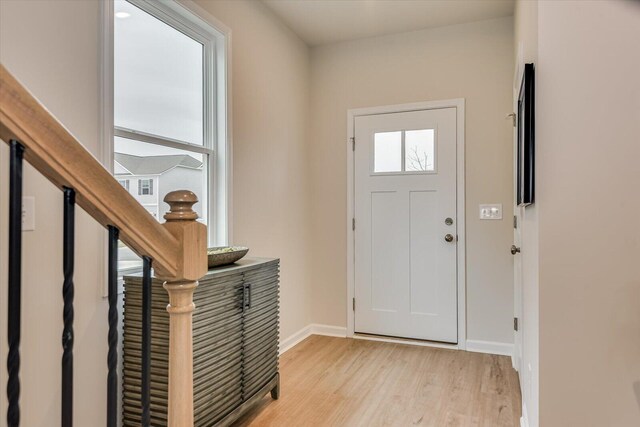 foyer entrance with light hardwood / wood-style floors