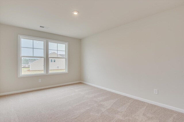 empty room featuring light carpet