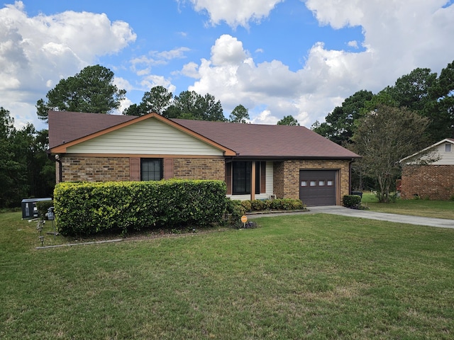 ranch-style house featuring a garage and a front lawn