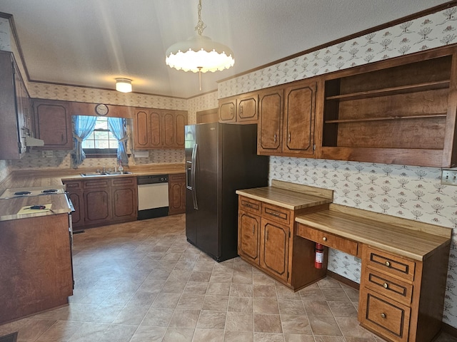 kitchen featuring dishwasher, sink, stainless steel refrigerator with ice dispenser, and decorative light fixtures