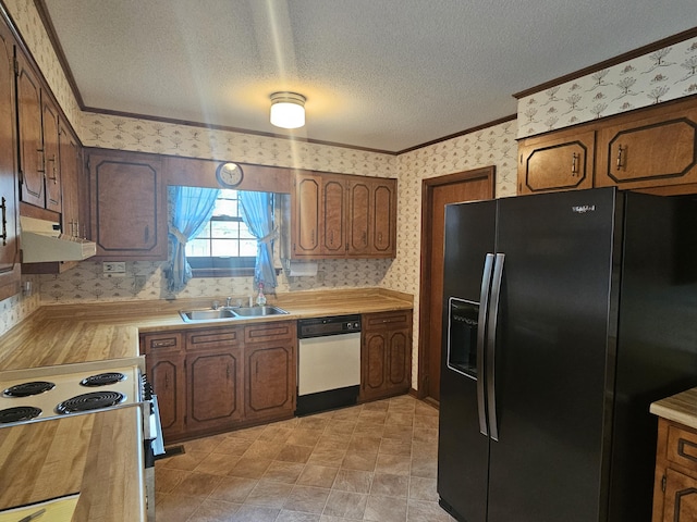 kitchen with a textured ceiling, crown molding, white appliances, and sink