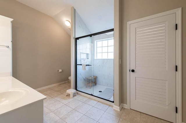 bathroom featuring tile patterned flooring, a shower stall, toilet, lofted ceiling, and vanity