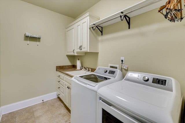 clothes washing area with cabinets, sink, washing machine and dryer, and light tile patterned flooring