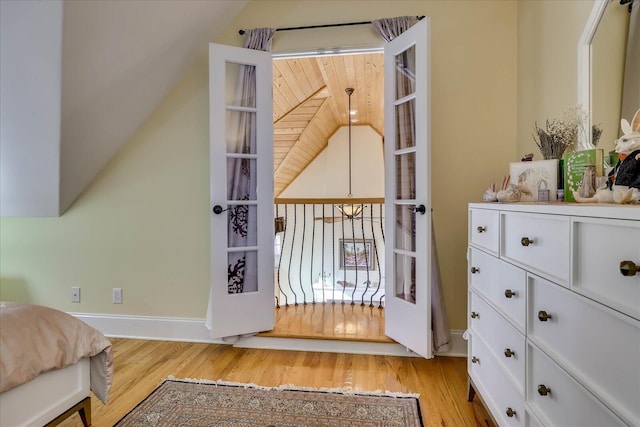 bedroom with lofted ceiling and light wood-type flooring