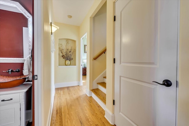 hallway with sink and light hardwood / wood-style flooring