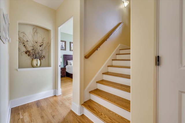 stairway featuring wood-type flooring