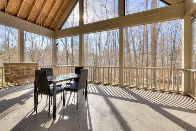 sunroom featuring vaulted ceiling and wooden ceiling