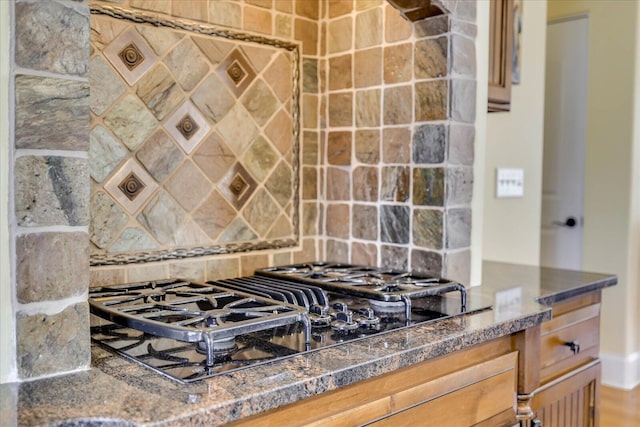 kitchen featuring backsplash and black gas stovetop