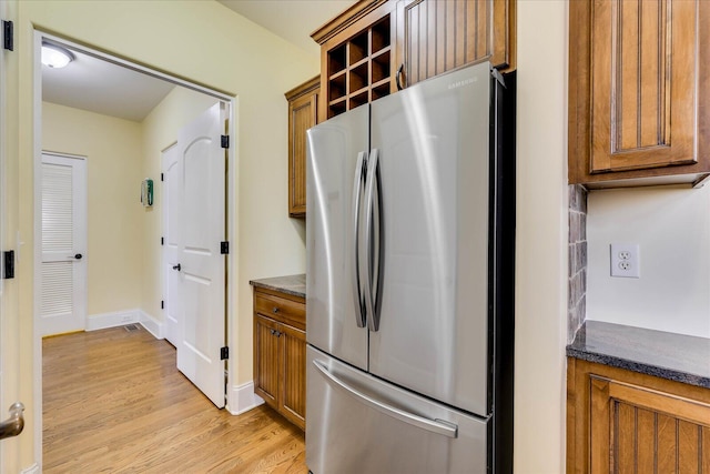 kitchen featuring stainless steel fridge and light wood-type flooring