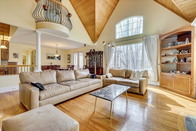 living room featuring light wood-type flooring, ornate columns, wood ceiling, and high vaulted ceiling