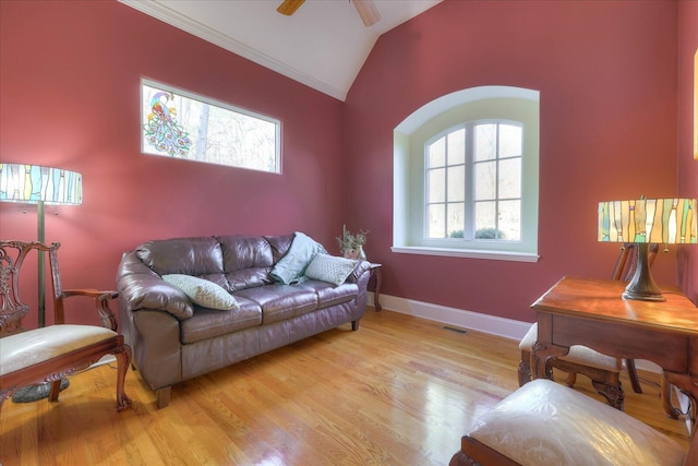 living room with ceiling fan, ornamental molding, light hardwood / wood-style flooring, and plenty of natural light