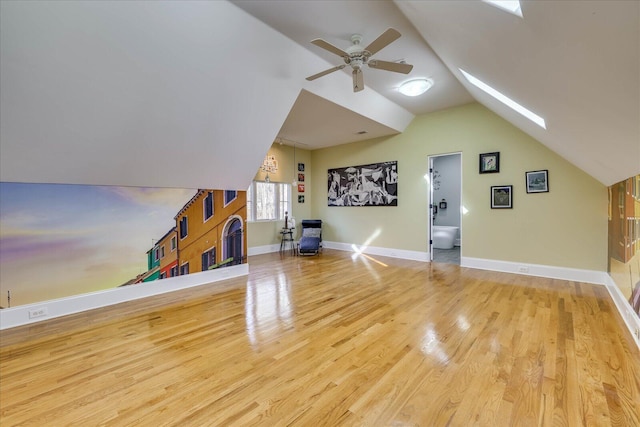 bonus room featuring ceiling fan, lofted ceiling with skylight, and hardwood / wood-style flooring