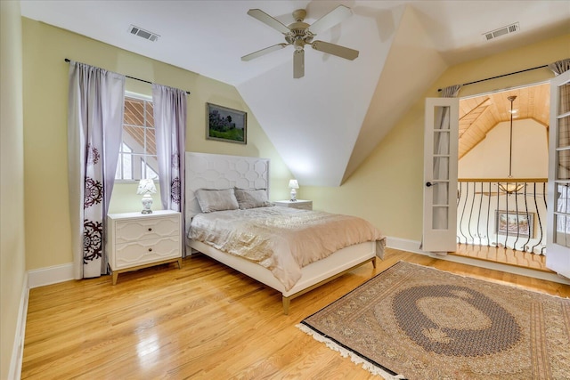 bedroom with ceiling fan, light hardwood / wood-style floors, and lofted ceiling