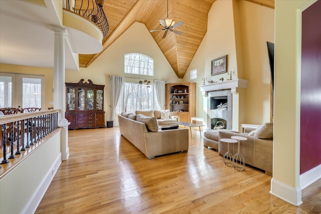 living room featuring ceiling fan, a wealth of natural light, and light wood-type flooring