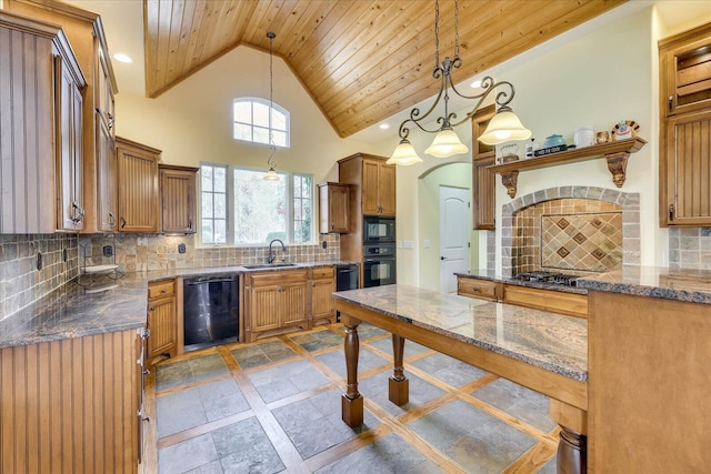 kitchen featuring pendant lighting, tasteful backsplash, and black appliances