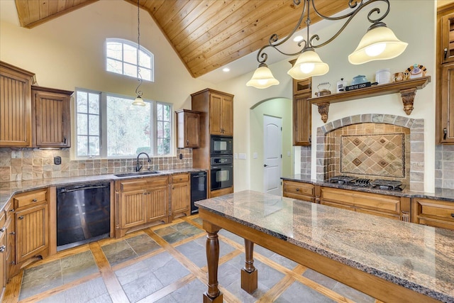 kitchen featuring black appliances, decorative backsplash, sink, and hanging light fixtures