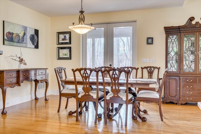 dining space featuring french doors and light hardwood / wood-style flooring