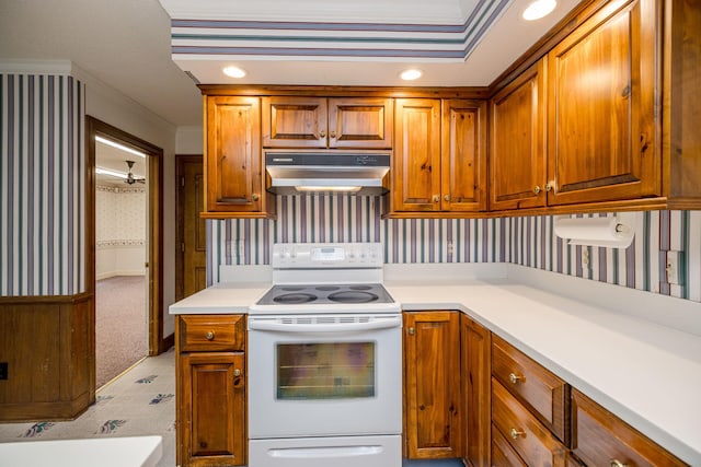 kitchen featuring white range with electric cooktop, light carpet, and ornamental molding