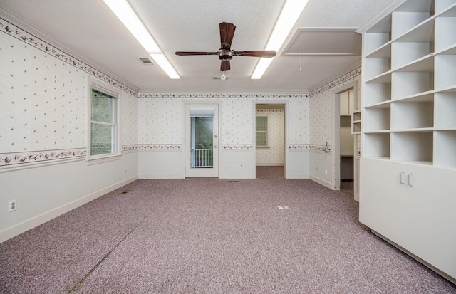 interior space with a textured ceiling, ceiling fan, and ornamental molding