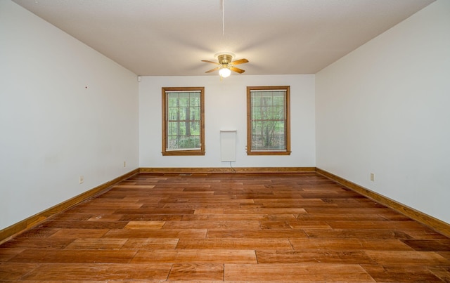 spare room with hardwood / wood-style floors and ceiling fan