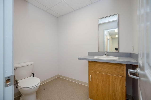 bathroom with vanity, a paneled ceiling, and toilet