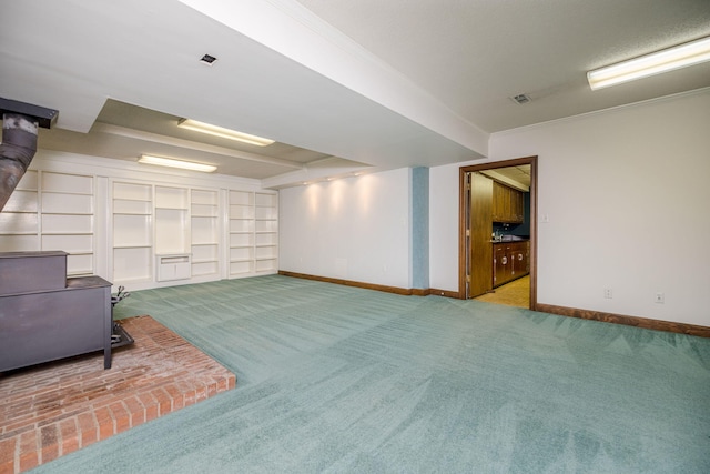 basement featuring crown molding and light colored carpet