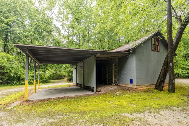 view of car parking featuring a yard and a carport