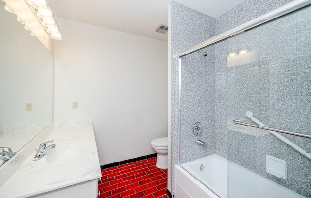 full bathroom featuring tile patterned flooring, vanity, toilet, and shower / bath combination with glass door