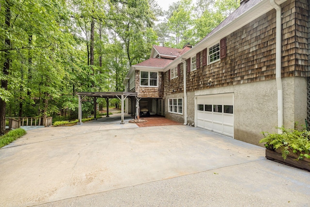 view of home's exterior featuring a garage and a carport