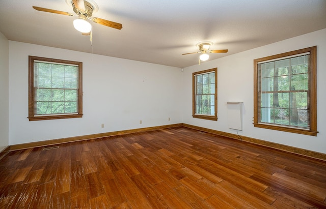 spare room with ceiling fan, hardwood / wood-style floors, and a textured ceiling