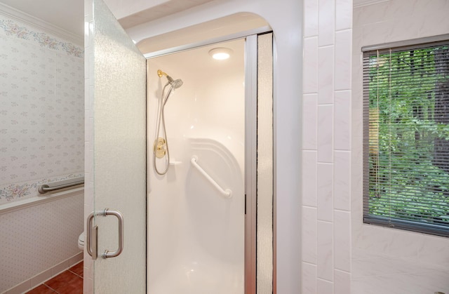 bathroom with a wealth of natural light, tile patterned floors, walk in shower, and ornamental molding