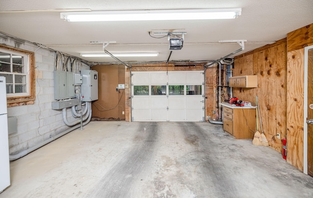 garage with electric panel and a garage door opener