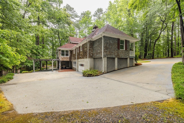 view of side of home with a garage and a carport