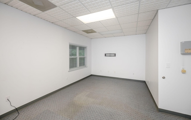 unfurnished room with a drop ceiling