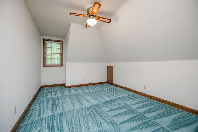 additional living space with a textured ceiling, ceiling fan, and lofted ceiling