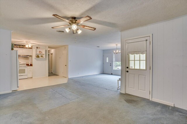 interior space with ceiling fan with notable chandelier and a textured ceiling