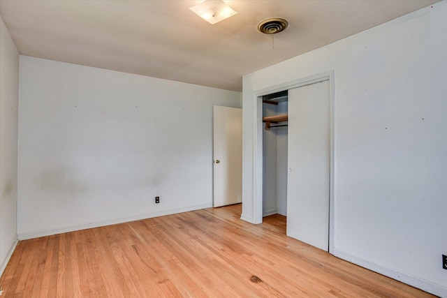 unfurnished bedroom featuring a closet and light hardwood / wood-style flooring