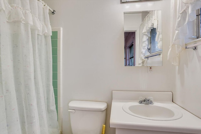 bathroom with vanity, toilet, and walk in shower