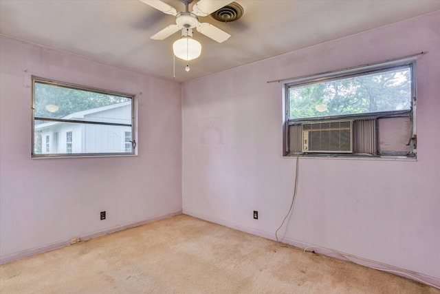 carpeted spare room with ceiling fan and cooling unit