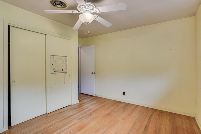 unfurnished bedroom featuring ceiling fan, a closet, and light hardwood / wood-style floors